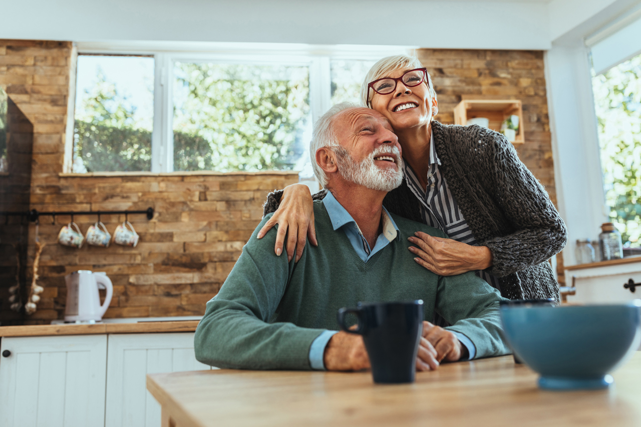 Old couple together in kitchen looking at equity options